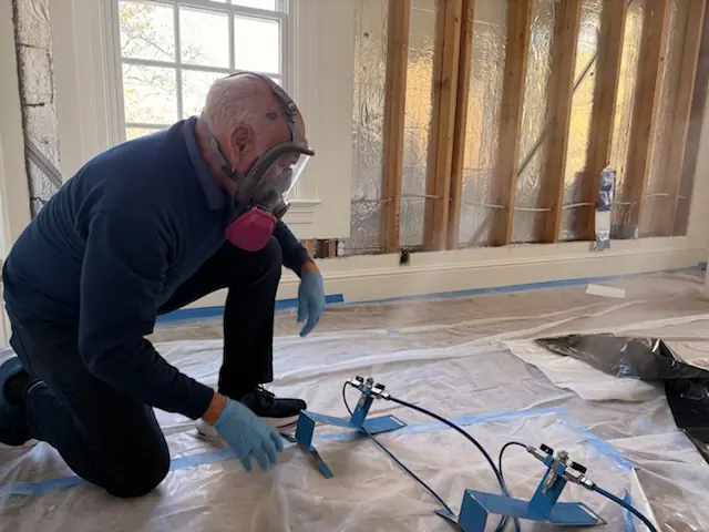 A restoration technician setting drying equipment in an San Jose home stripped to the studs