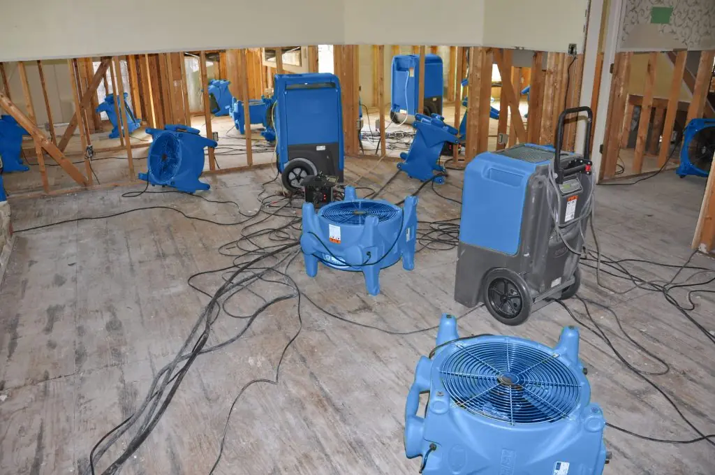 Air movers drying a gutted San Jose room after major water damage
